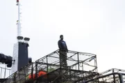 Munsy, Engineer aboard the Southern Wind, stacks pots.
