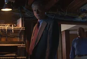 Mikels looks in Robert Petrick's computer room.