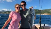 Contributors Mike Cutright (R) and Nicolette Cutright (L) are all smiles celebrating their big catch of the day in St. Thomas as seen on HGTV's Beachfront Bargain Hunt.