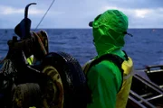 Taylor Jensen, greenhorn on the Cornelia Marie, mans the line as a pot is pulled aboard.