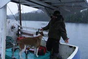 Oliver Johnson and his dog on his boat before performing a "shakedown cruise."