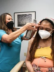 Dr. Lee uses liquid nitrogen on Edith Brown’s black spots.