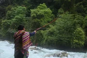 Dulong Valley, Dulong - Chen firing string across river using a crossbow.