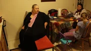 Angela Sits at table with family members