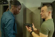 Mario (Paul Wollin, r.) prahlt vor seinem Kollegen Mané (Emmanuel Ajayi, l.) mit seiner Pistole.
