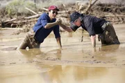 Travis Geske helps cameraman Monte Duarte from sinking in the mud in Telachapi, California.