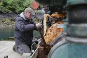 Sam Carlson makes critical repairs to the water canon from the town's fireboat.