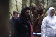 Harper (Andrew Gower, l.) und Ellis (Sharon D Clarke, M.) stehen mit der Gerichtsmedizinerin CSI Christine Bennett (Kirsten Foster, r.) am Leichenfundort, einem Waldstück.