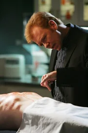 Horatio (David Caruso) schaut sich Bob Keatons Leiche genauer an und entdeckt einen eigenartigen Abdruck auf dem Brustkorb.