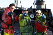 Freddy Maugatai, Roger Schlosstein, and "OJ" Ganuelas pose together aboard the Wizard.