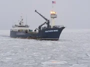 The Southern Wind treks through sheets of ice on the Bering Sea.
