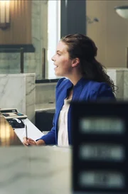 Recre- Ed speaks with bank teller.