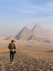 Ramy Romany walking towards pyramids.