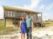 Homebuyers, Jacob Davis (R) and Tori Morehead (L) posing by the first home.
