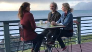 Contributors Mark Neisler (C) and Lori Hopkins (R) sit with real estate agent Shannah Marenghi (L) to tell her what they're looking for in a future home in Shelter Cove as seen on HGTV's Beachfront Bargain Hunt.