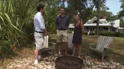 Realtor, Chris Haro (L) talking to the homebuyers, Andy (C) and Sheila Smith (R) by the fire pit at the second home.
