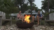 Homebuyers, Andy (R) and Sheila Smith (L) enjoying their new fire pit at the second home.