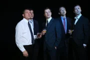 Men in suits with cocktails.