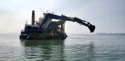 A shot of the Myrtle Irene in action as it digs for buried gold.
