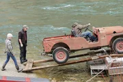 L-R:  Heinz Sippel and Joni Dewey watch over as Buck Dewey backs up the jeep off the boat.