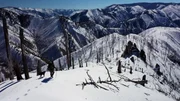 Aubrey Barton with her dog Hamms walking in the snowy mountain landscape