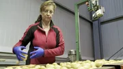 Christa Markut selecting the potatoes