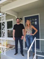 Christina and Tarek pose outside their latest successful flip in Yorba Linda, CA. As seen on HGTV's Flip or Flop.