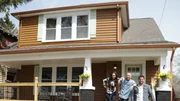 (After 2) Another shot of the Hosts on the front porch after renovations, as seen on HGTV's Bargain Block