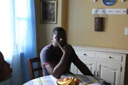 Reggie Brooks sits at the kitchen table. Reggie Brooks sits at the kitchen table.