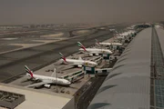 DUBAI AIRPORT, UAE - Wide shot of the left wing of Concourse B from the Air Traffic Control tower, overlooking a fleet of Emirates planes.