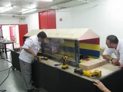 Buddy Valastro (L) and Frankie work on moving parts of the car wash cake.