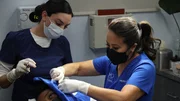 Dr. Sandra Lee procedure on Mikalia S. ear nevus with the help of her assistant, Janet C.