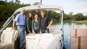 Portrait of Fixer Upper Hosts Chip and Joanna Gaines (R) with homeowners Allen and Gaile Holt (L) on the boat they arrived on for the reveal of their river-front home, as seen on Fixer Upper.