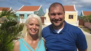 Exterior, Clients Anton and Holly posing in front of house in Aruba. As seen on HGTV's Caribbean Life