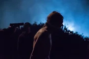 They drag Ernie (Daniel Wessels) to the river's edge.