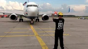 Die siegreiche Mannschaft von Eintracht Frankfurt zurück am Flughafen Frankfurt, der Europapokal und die Eintracht-Fahne stolz aus dem Cockpitfenster gehalten.