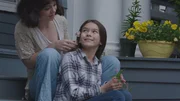 Kelli Cervantes and her mother Noni sit on the porch steps.