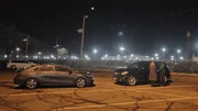 Mariana van Zeller talking to a masked subject in a parking lot.