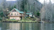 The exterior of the first home which is located on a small island named Loon Island. The exterior of the first home which is located on a small island named Loon Island.