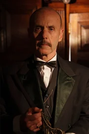 Recon - Cast depicting Heinrich Schliemann in his office