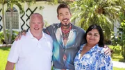 From left to right: Robert Douglas, Host David Bromstad, and Swati Dave pose for a picture outside of House 1, Dahoon Drive, as seen on My Lottery Dream Home, Season 17.