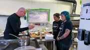 Chef Robert Irvine shows Julene Price, owner of Amigo Café, and Heather, daughter of Julene/ server at the restaurant, how to make the entrées from the new menu for Amigo Café in Kayenta, AZ, as seen on Restaurant: Impossible, Season 20.