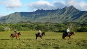 Home buyers Mike Hopper (L) and RaeNell Hopper (R) on a horseback riding trip as seen on Hawaii Hunters (Action)