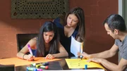 Giselle, Lucy and Frank making posters for an awareness walk to find Maribel.