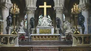 Eine ruhige Darstellung des Innenraums einer katholischen Kirche mit einem Altar.