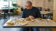Chef Robert Irvine reviews the food from the old menu at Sunnyside Café in Williamston, MI, as seen on Restaurant: Impossible Season 20.