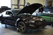 The Mustang raised with trunk open.