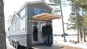 Tiny house owners Steve and Holly pose for the camera standing on their back deck, for Steve and Holly Schuett's tiny house build, in Gleason, Wisconsin, as seen on Tiny House, Big Living