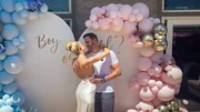 Wide shot of Heather and Tarek at their gender reveal party.