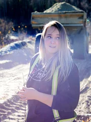 Monica Beets on dykes with rock truck in background